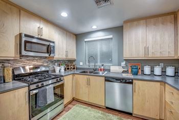 A kitchen with wooden cabinets and stainless steel appliances.
